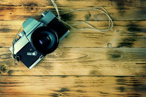 Depositphotos 95034228 stock photo vintage camera on wooden background
